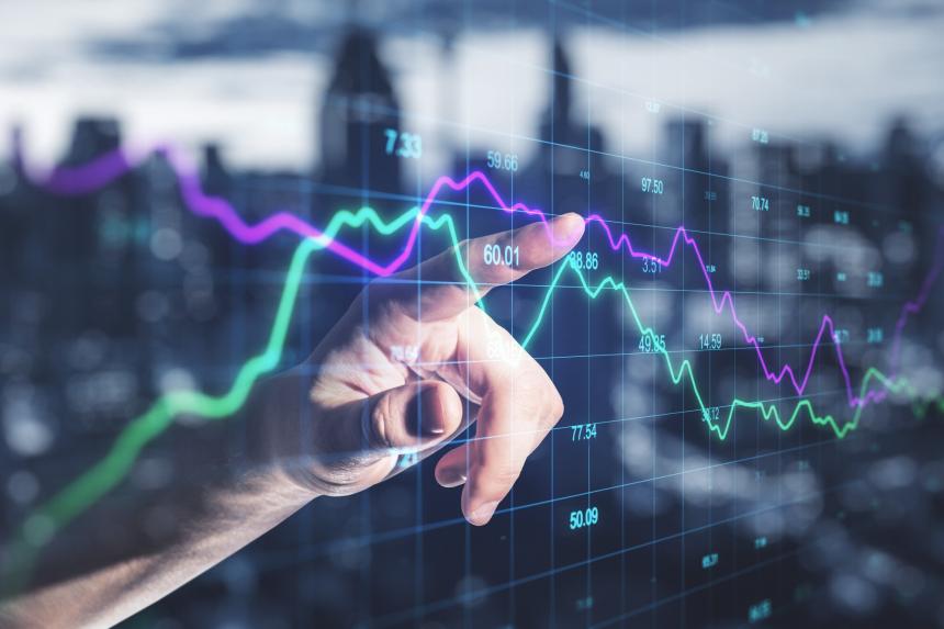 Pointed finger resting against a chart on a digital board, skyline of city reflected on board.